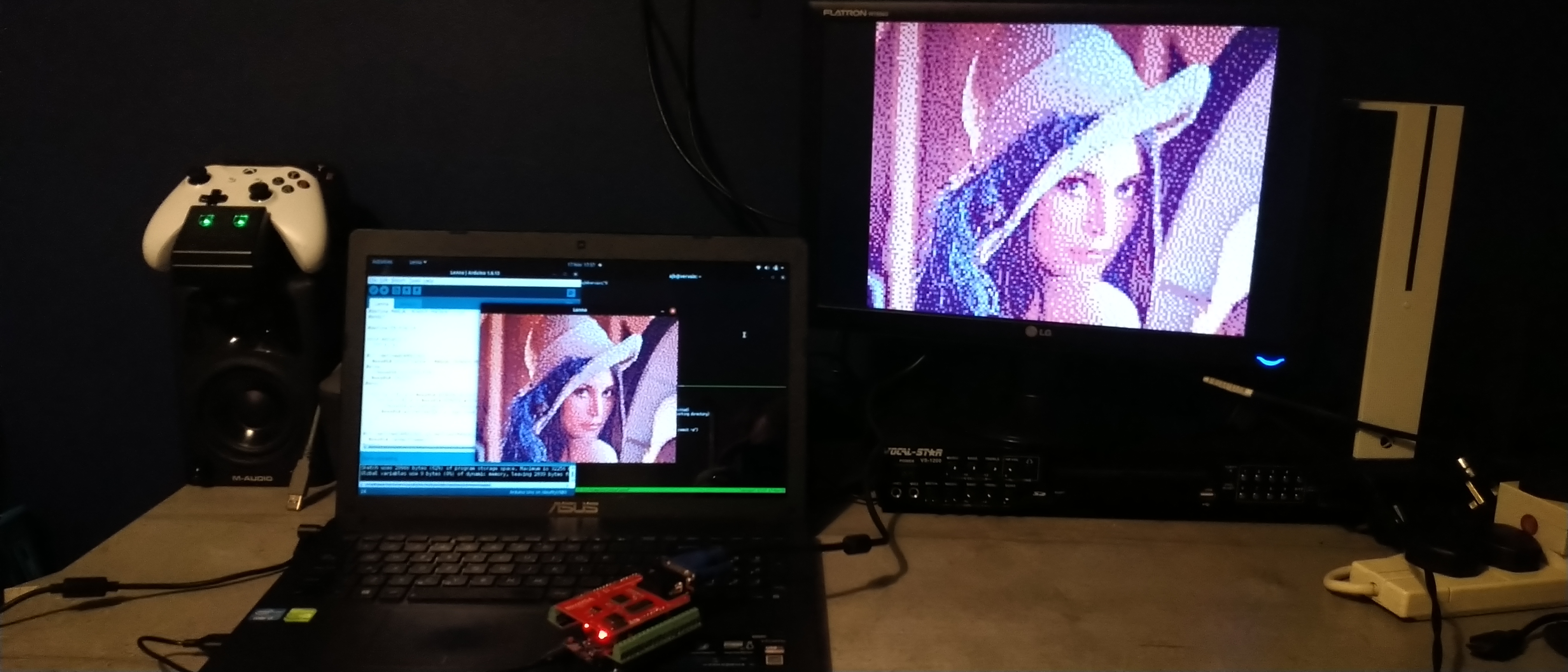 Photo of a laptop and VGA monitor both displaying the same picture of a woman